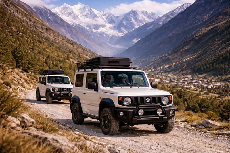 Wide angle view of Suzuki Jimny self drive cars on a Himalayan mountain road in Manali, rented by travelers for adventure trips